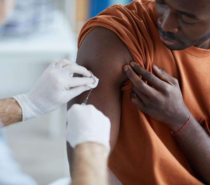 An African American man getting vaccinated