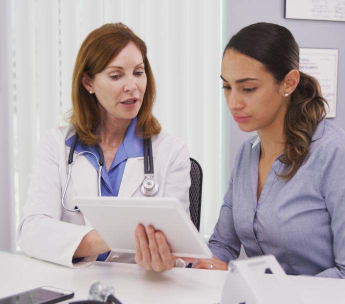 doctor reviewing charts with woman
