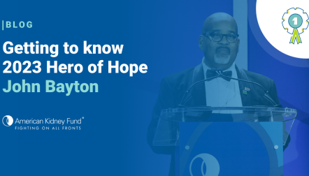 John Bayton in a tuxedo at a podium at The Hope Affair with a blue text overlay "Getting to know 2023 Hero of Hope John Bayton"