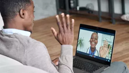 A middle aged man using a telehealth service