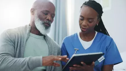 A nurse talking to an elderly patient