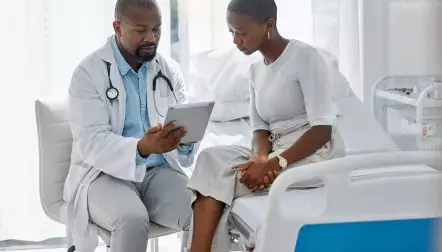 A doctor talking to a young female patient