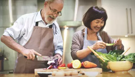 An older couple cooking together