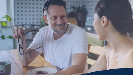 Man talking to woman at table