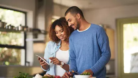A young couple cooking in the kitchen