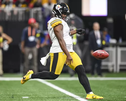 Pressley Harvin III kicking a football during an NFL game