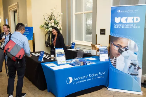 AKF staff welcoming participants at the UCKD Summit booth