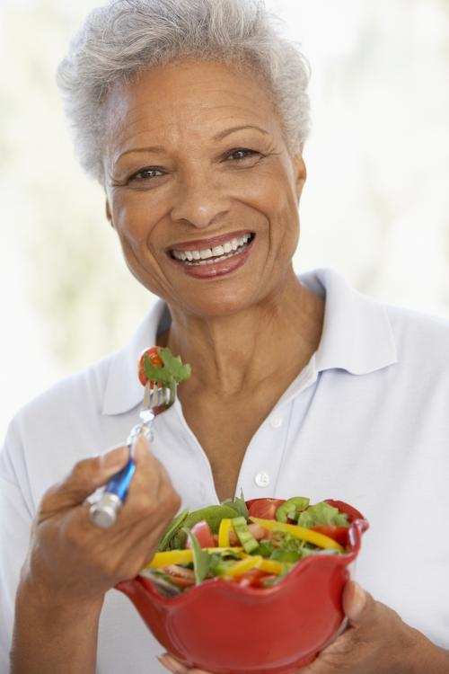 black senior woman with salad