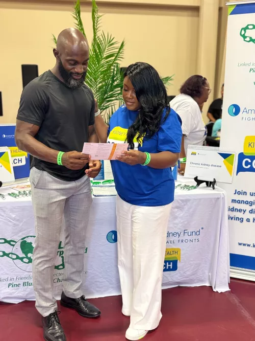 Nicole Bates talking with a man at a health fair