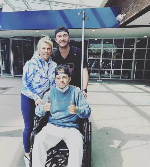 Jackie Medici's brother in a wheelchair with family behind him