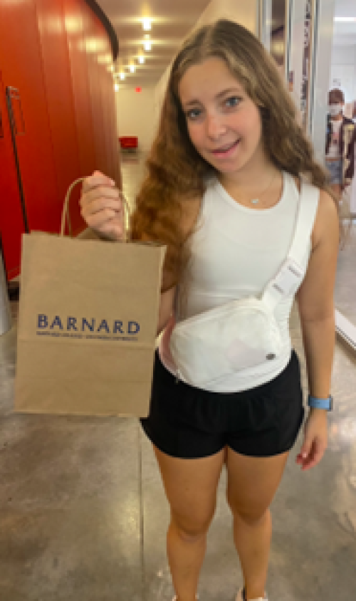 Lily Goldstein holding up a Barnard College bag