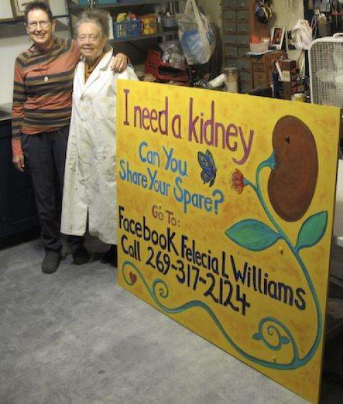 Linda Griggs and Mary Ellen standing next to a "I need a kidney" sign