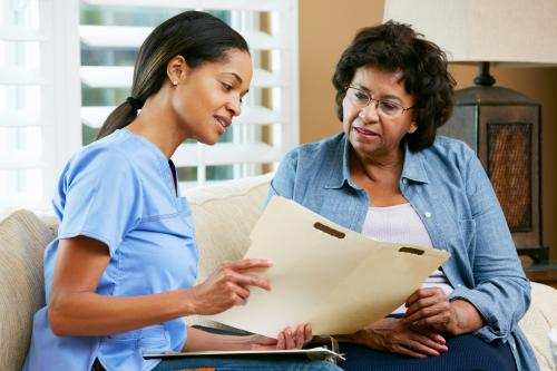 black nurse advising senior woman