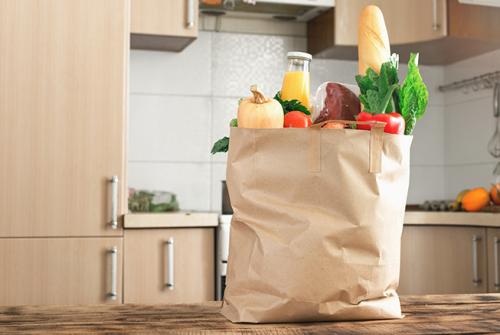 brown paper shopping bag filled with fresh vegetables