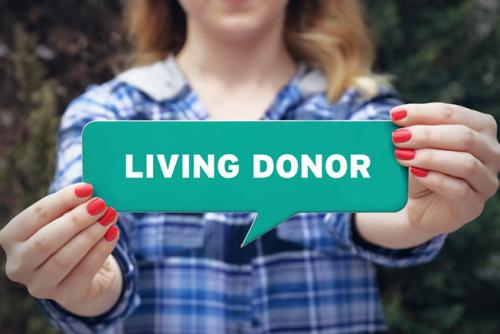woman holding sign that says living donor