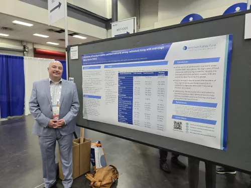 Michael Spigler in front of a research poster at the ASN conference