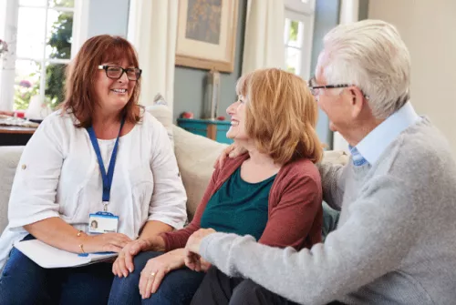 social worker talking with older couple