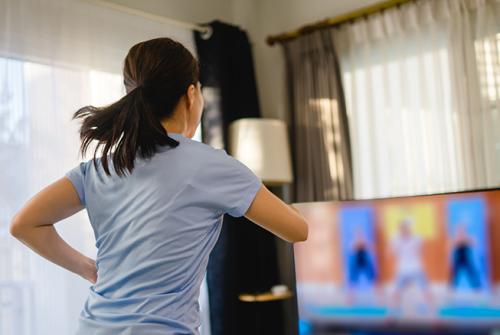 Woman workout in front of television.