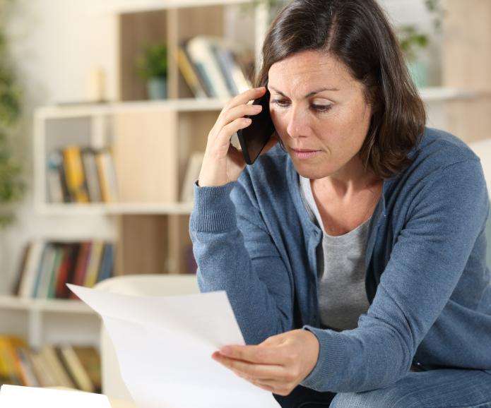 Woman on the phone reviewing a paper
