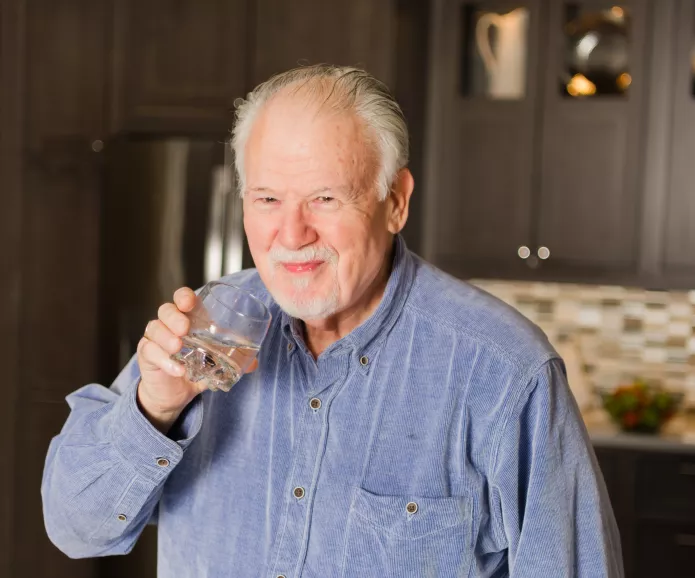 white senior man drinks water akfshoot