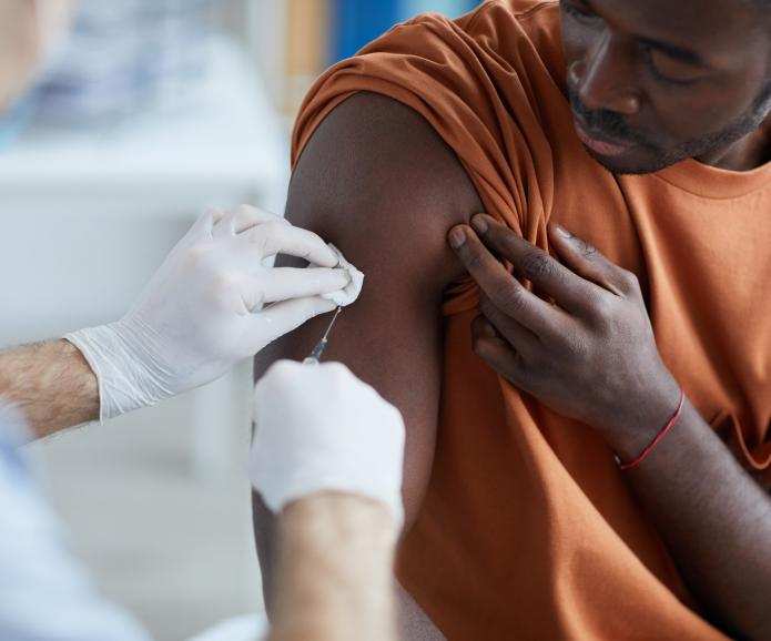 An African American man getting vaccinated