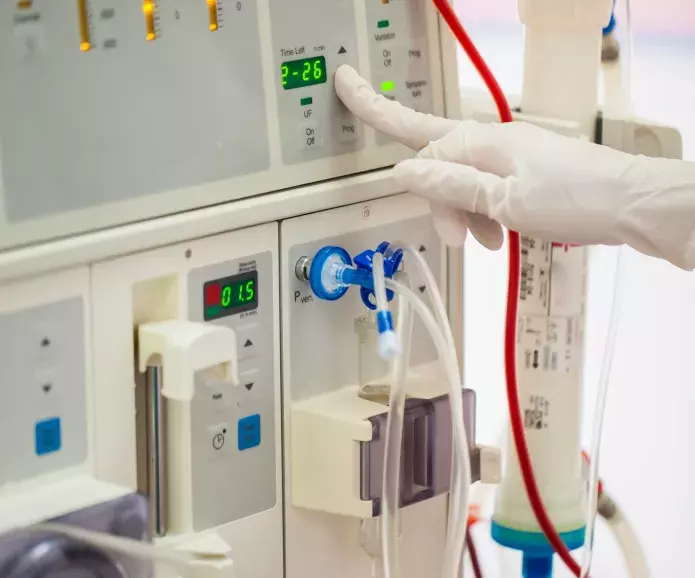 dialysis tech hand working with machine