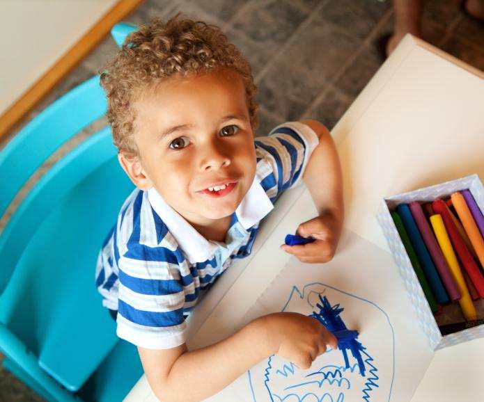 mixed race boy painting shutterstock 112482695