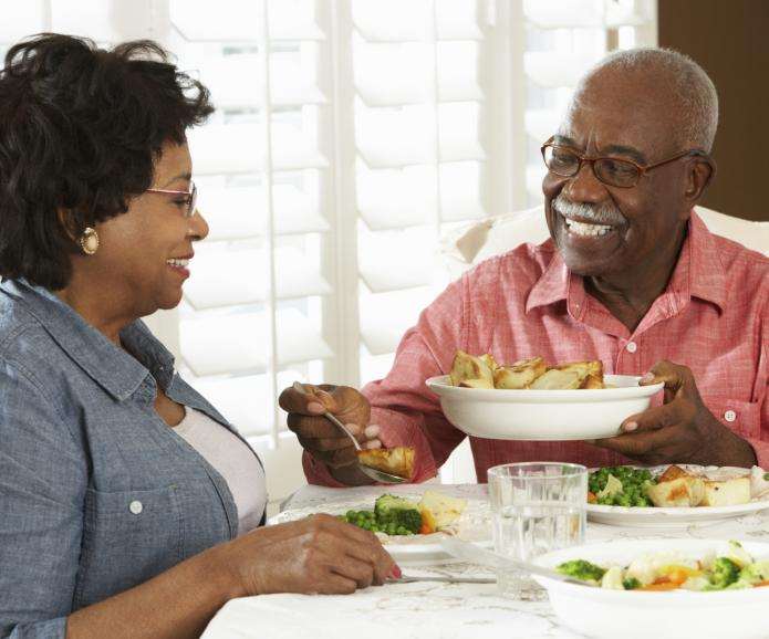 black senior couple eating dinner