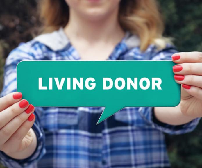 woman holding sign that says living donor