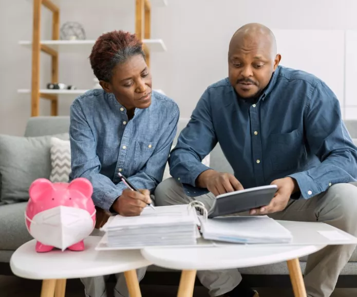 Older Black couple sitting in the Livingroom