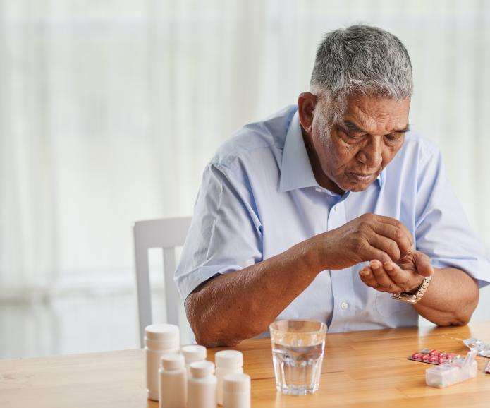 senior man counting pills