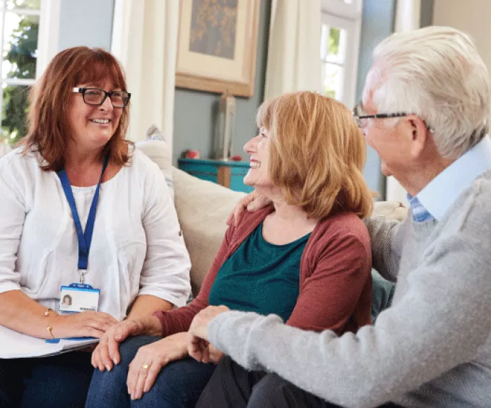 social worker talking with older couple
