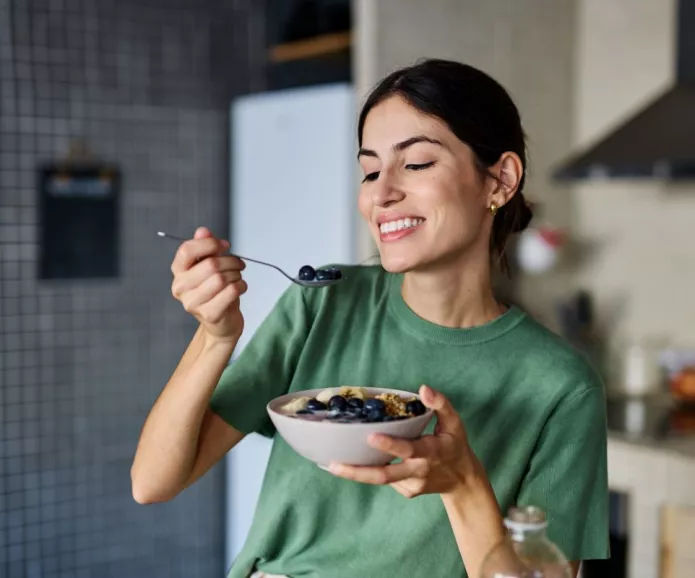 A young woman eating a healthy snack