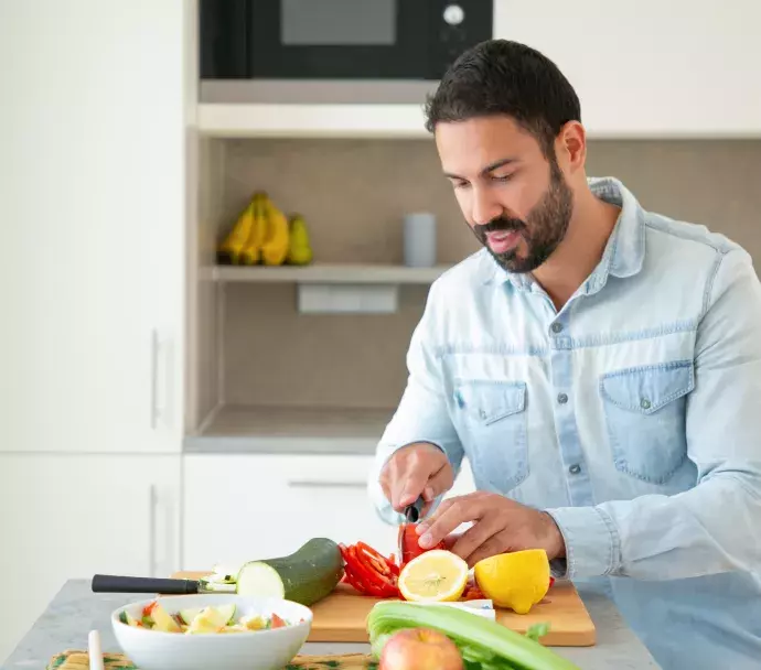 white man chopping vegetables