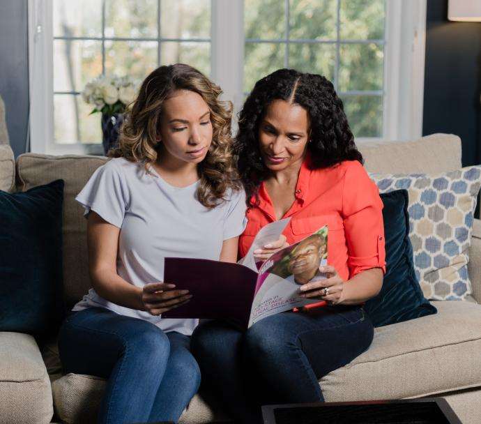 two black women read manual on couch akfshoot 2