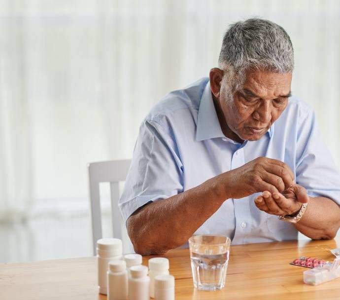 senior man counting pills