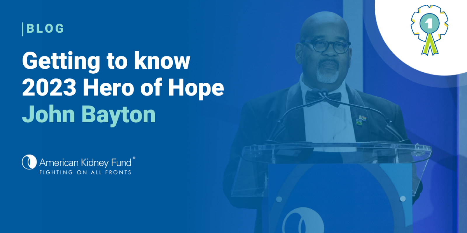 John Bayton in a tuxedo at a podium at The Hope Affair with a blue text overlay "Getting to know 2023 Hero of Hope John Bayton"