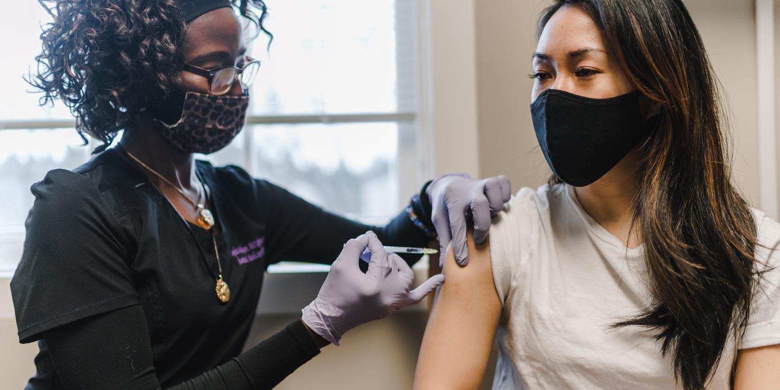 black nurse giving patient vaccine TONL 14859