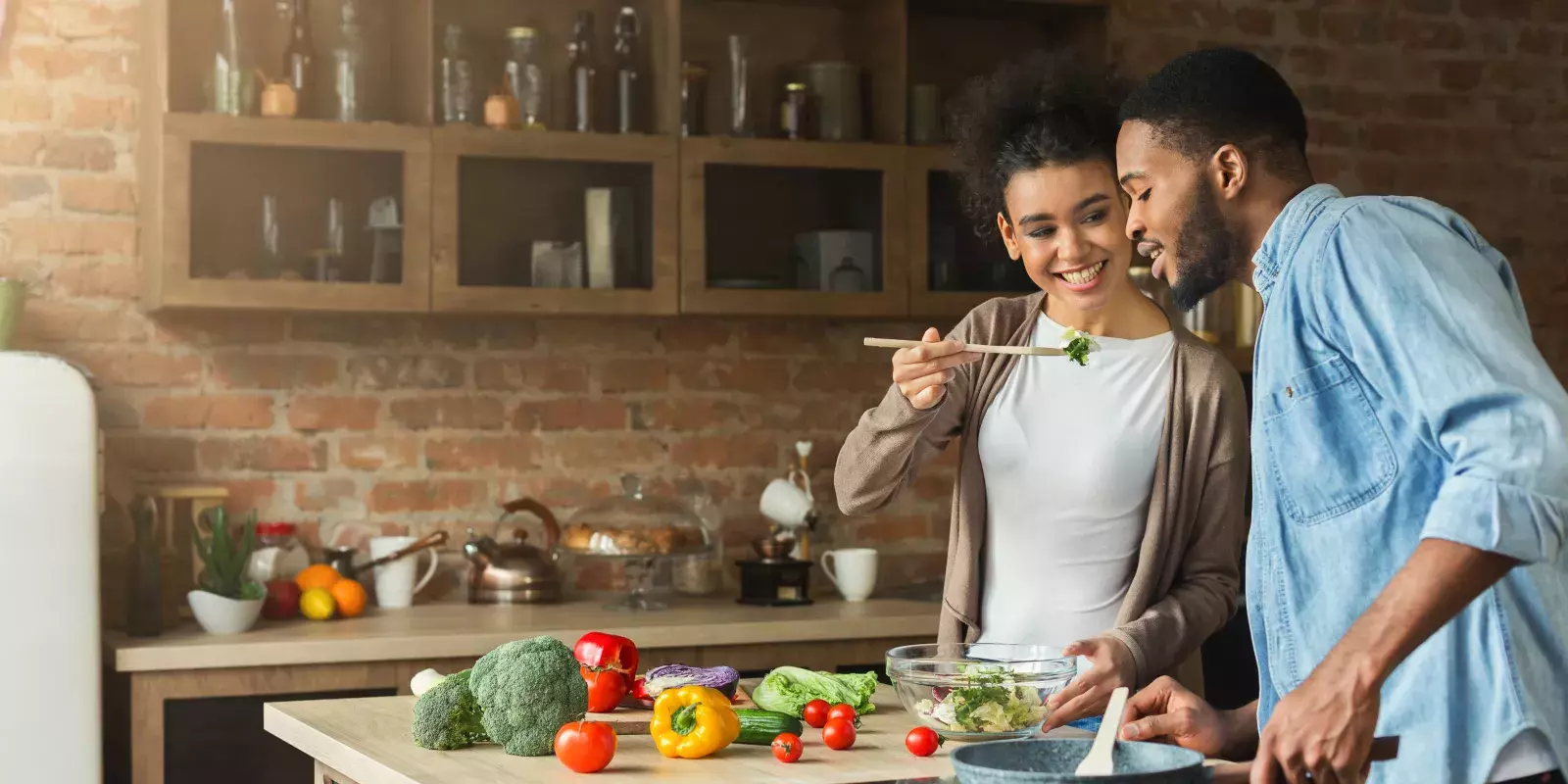 black couple sharing food chopsticks