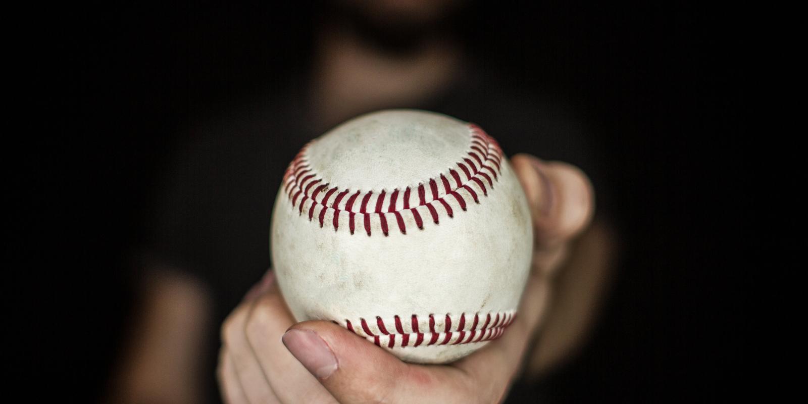 man holding baseball