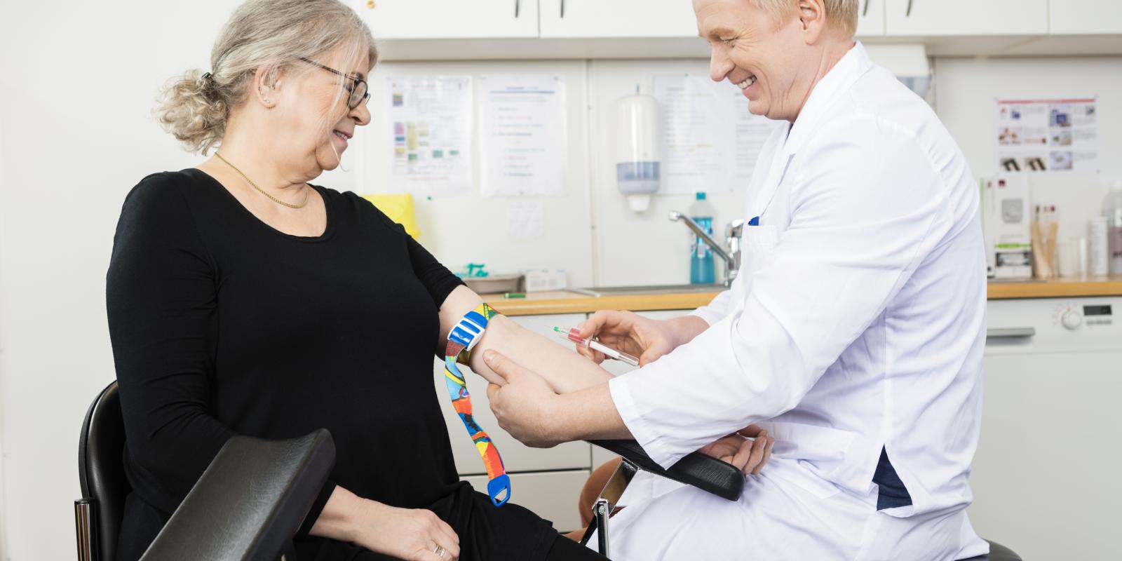doctor giving white woman blood test