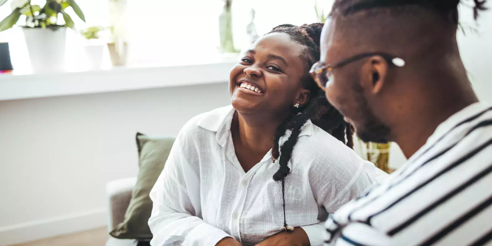 A couple laughing and smiling indoors