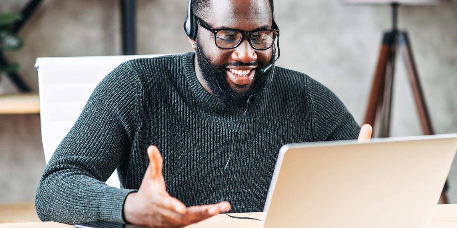 Black man attending a virtual meeting