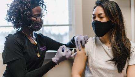 black nurse giving patient vaccine TONL 14859