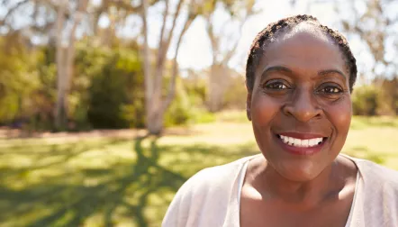 A smiling black woman outdoors