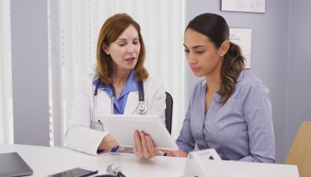 doctor reviewing charts with woman