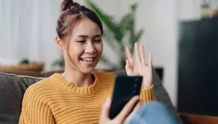 woman waving on the phone