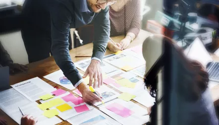 Overhead shot of people working in the office on financials